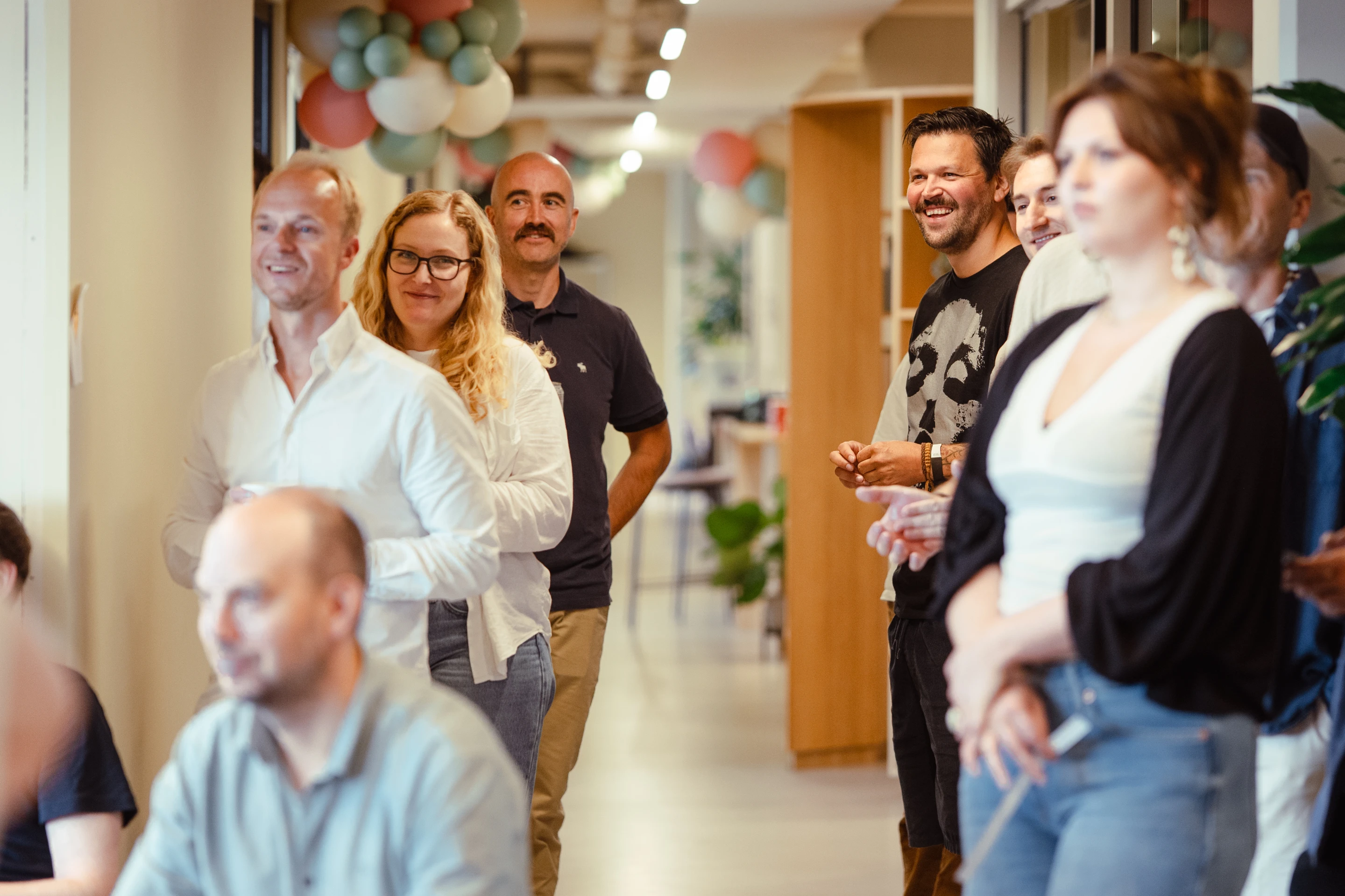 The Oslo team gathered in the lounge area listening to a presentation