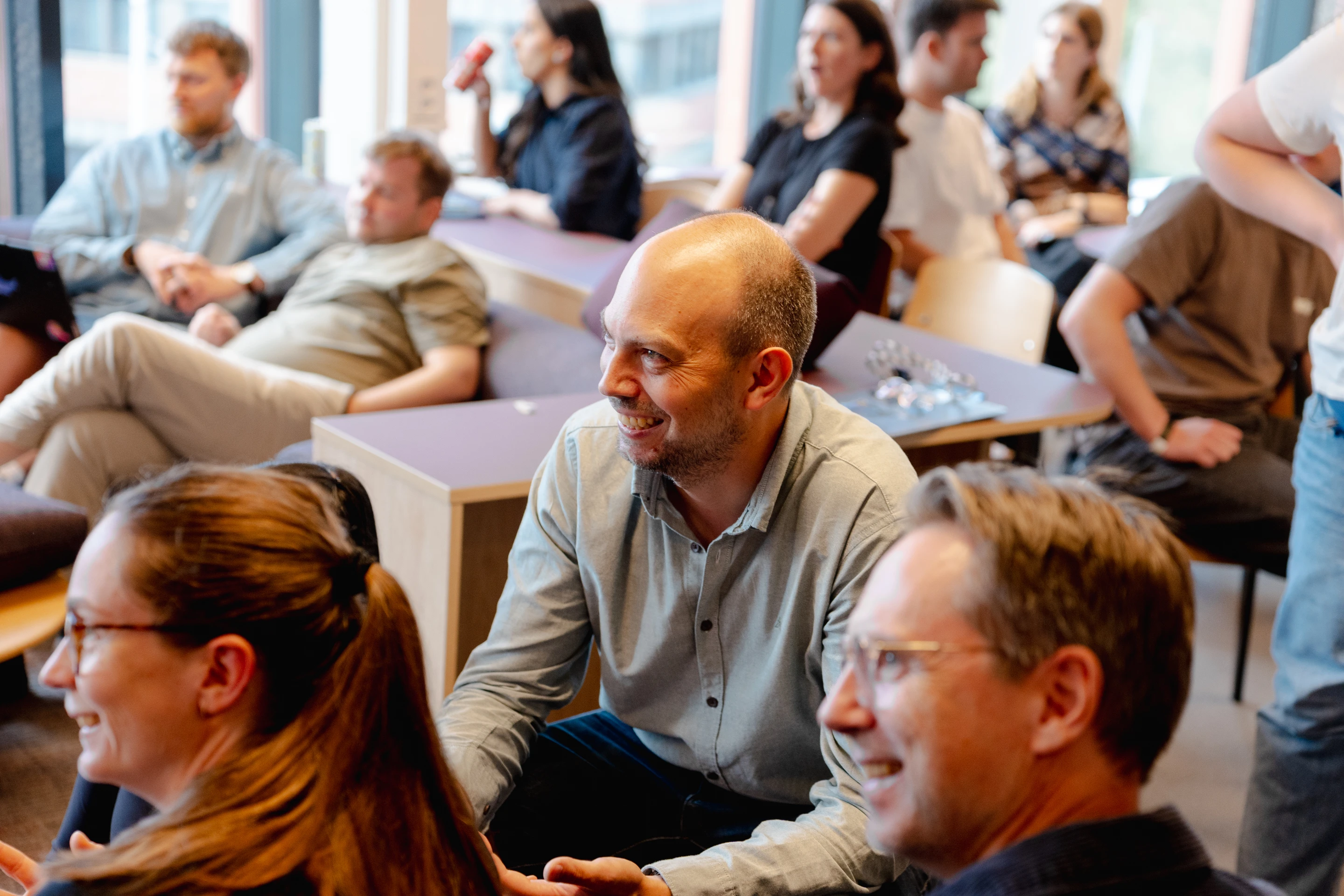 The Oslo team gathered in the lounge area listening to a presentation
