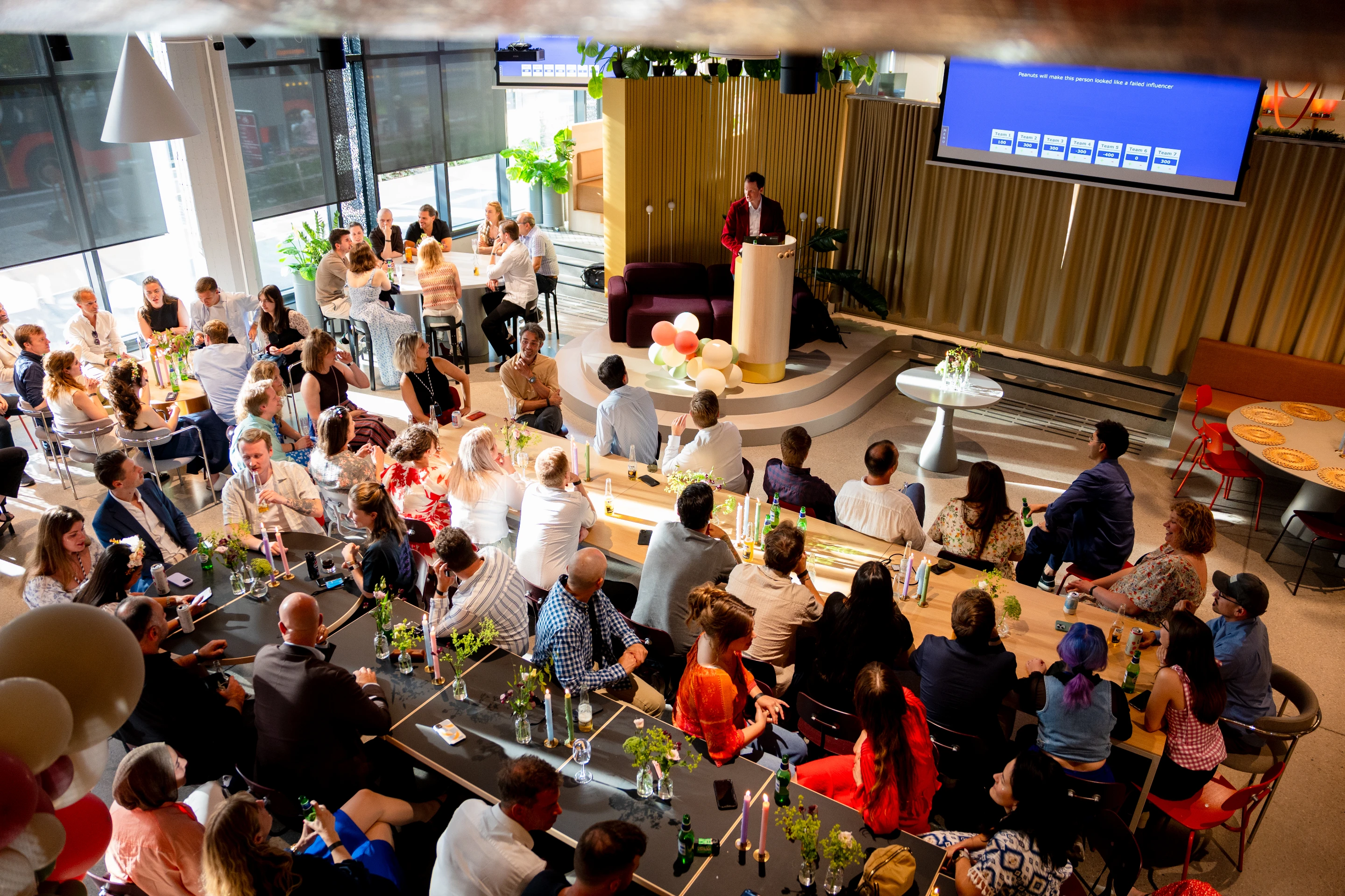 The whole Nettbureau development team gathered in front of the balloon wall at the summer party in Oslo