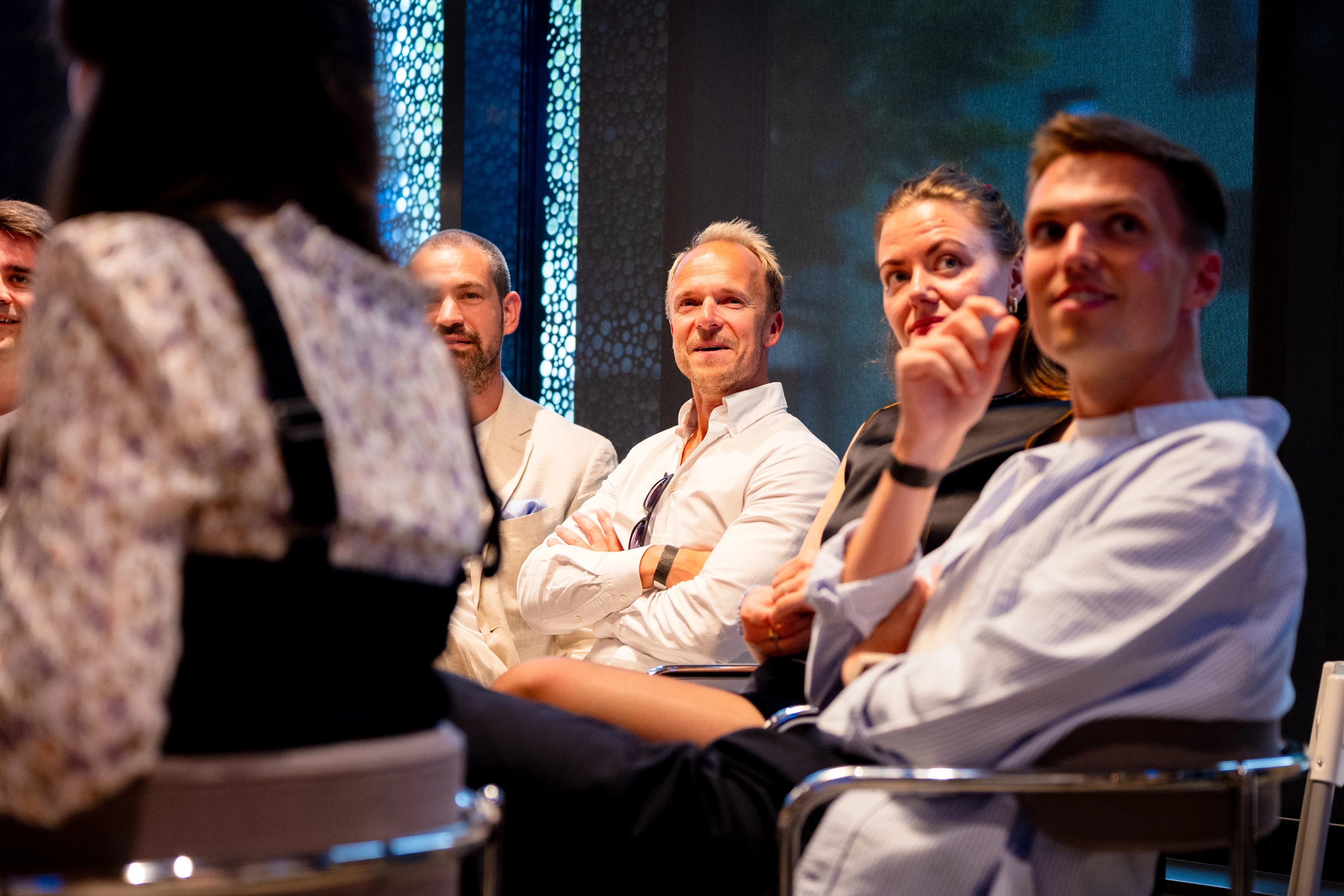 Colleagues seated together at a company event