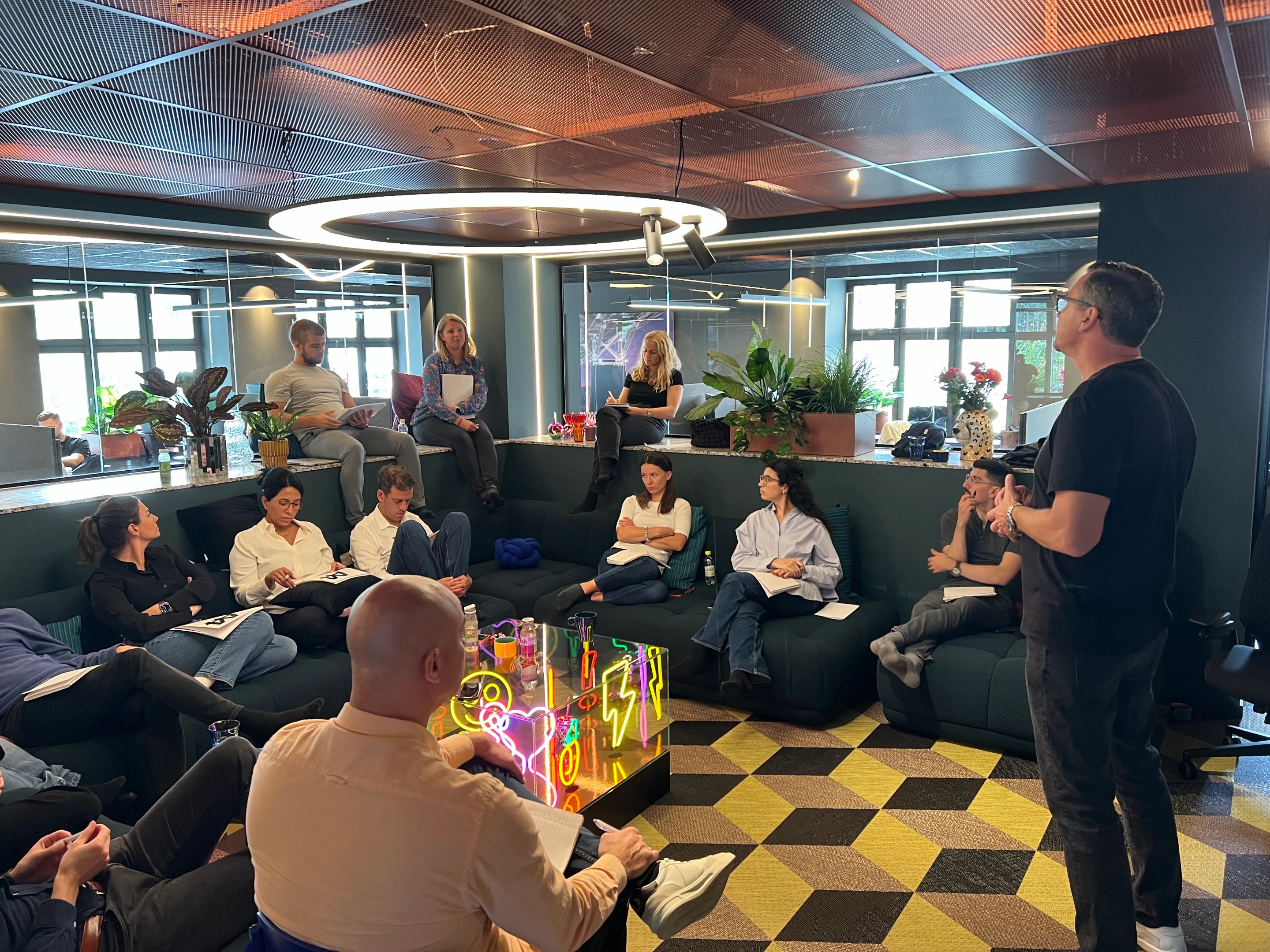 A colleague presenting from a laptop during an internal B2B workshop at the Oslo office